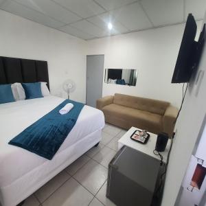 1 dormitorio con 1 cama grande y 1 sofá en De Bliss Lodge en Johannesburgo