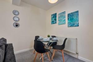 a dining room with a table and chairs at Comfy Home on Burton Road in Derby