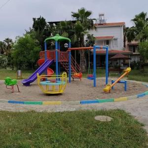 a playground in a park with a slide at VİLLA KEYF in Side