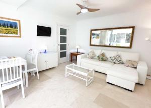 a living room with a white couch and a table at 1 Bedroom Apartment Second Line Beach- Parque Marbella Building in Marbella