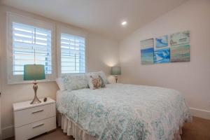 a white bedroom with a bed and a window at Bayside Cove 2 in San Diego
