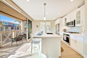 a kitchen with a white counter and a balcony at Bayside Cove 4 in San Diego