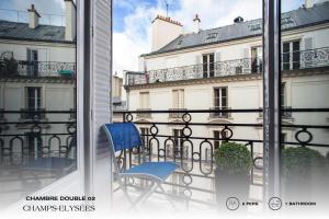 a balcony with a blue chair and a building at Beauquartier - Champs-Elysées in Paris