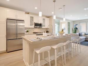 a kitchen with a large island with bar stools at Bayside Cove 3 in San Diego