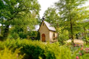 a small chapel in the middle of a garden at Haus Mariengrund in Münster