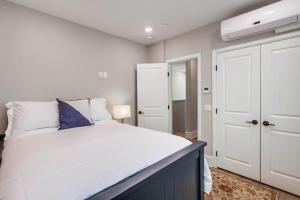 a bedroom with a large white bed and a white closet at Bayside Cove 4 in San Diego
