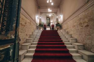 a staircase in a building with a red carpet at Mazeej Balad in Cairo