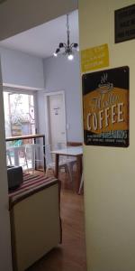 a room with a sign for a table coffee brewing at LUCO HOTEL in Buenos Aires