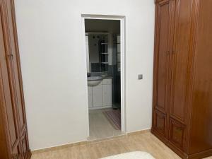 a hallway with a bathroom with a sink and a mirror at la laja 38 in Las Palmas de Gran Canaria