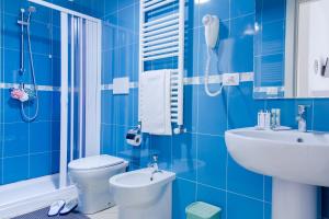 a blue bathroom with a toilet and a sink at Sterlizia Rooms in Gallipoli