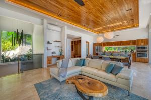 a living room with a couch and a table at Casa Heliconia in San Luis +21 photos