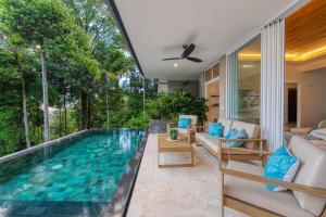 a swimming pool in the middle of a house at Casa Heliconia in San Luis