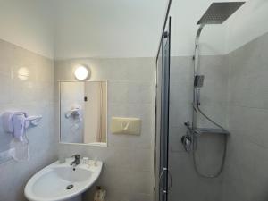 a bathroom with a shower and a sink and a shower at Garden Hotel Alghero in Fertilia