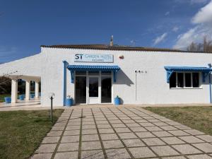 a white building with a sign that reads st catherine hospital at Garden Hotel Alghero in Fertilia
