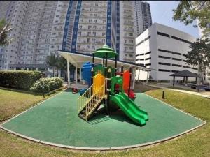 a playground with a slide in a park at The Grass Residences in Manila