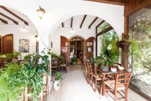 a restaurant with tables and chairs and plants at Turismo Rurale La Miniera Fiorita in Arbus