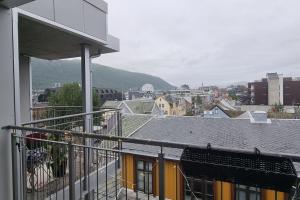 a balcony of a building with a view of a city at Relax in a cozy studio overlooking downtown in Tromsø