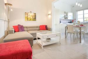 a living room with a couch and a table at Bright & Airy St. Julian's flat in Il-Gżira