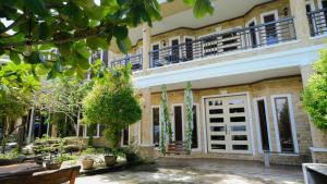 an exterior view of a building with a white door at Castle View Hotel Samal in Magamomo