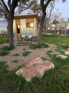 a house with a picnic table and two trees at En Suite Flora in Dripping Springs