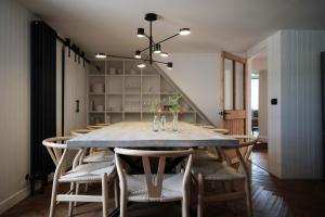 a dining room with a table and chairs at Ballintaggart Farmhouse in Logierait