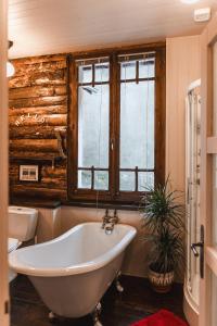 a bathroom with a tub and a window at Les Ruisseaux in Cauterets
