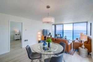 a living room with a table and a couch at Capri by the Sea in San Diego