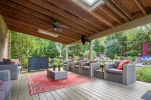 a covered patio with couches and a television at York Vacation Rental about 26 Mi to Spooky Nook Sports in York