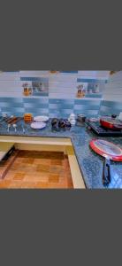 a kitchen with a counter top with dishes on it at SAI BALAVANY RESIDENCY Pondicherry in Puducherry