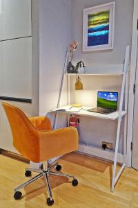 a desk with a chair and a computer on it at Central London 1 bedroom flat in Kensington in London
