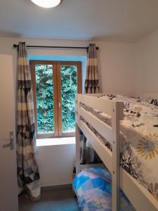 梯也爾的住宿－La Caravelle 3，一间卧室配有双层床和窗户。