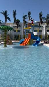 a water park with a slide in the water at ACAPULCO Vidanta Villa alberca privada acceso playa in Acapulco