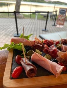 a plate of food with meats and vegetables on a table at Chalet 2 étoiles - ef0bdg in Neffes