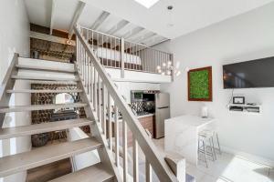a white kitchen with a staircase and a table at Kettner Row 2 in San Diego