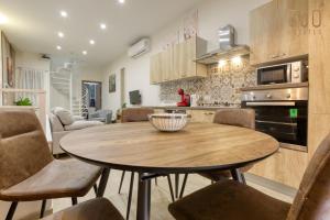 a kitchen and living room with a wooden table and chairs at Authentic & Spacious 3BR home with Private Terrace by 360 Estates in Rabat