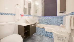 a bathroom with a white toilet and a sink at Comfort Double Room St. Julian's in Il-Gżira +9 photos