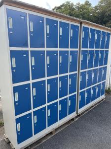 a row of blue lockers in a parking lot at Wies'n Camp in Munich
