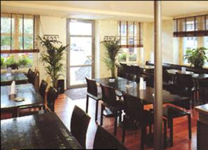 a dining room with tables and chairs and a restaurant at Hotel Ochsen in Uster
