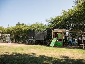 a park with a playground with a slide at Campingplatz Johannisberg in Fehmarn