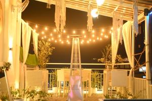 a marquee with lights and a table and chairs at Royal Castle in Kasol
