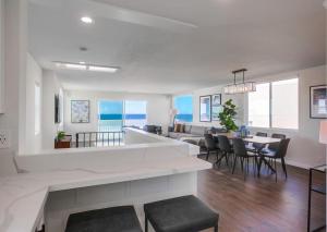 a kitchen and living room with a table and chairs at Rip Tide in San Diego
