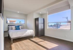 a bedroom with a bed and a large window at Rip Tide in San Diego
