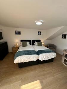 a bedroom with a large bed in a attic at The Highmead in Blackwood