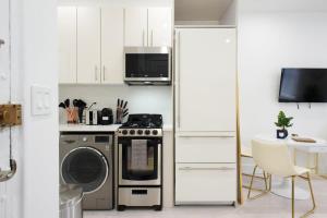 a kitchen with a stove and a microwave at 62-3A NEW Prime UES W D in unit Walk 2 C park in New York