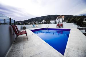 a swimming pool on the roof of a building at Apart Riviera Tower Suites in Villa Carlos Paz