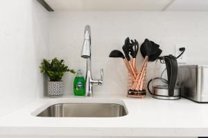 a kitchen sink with utensils on a counter at 62-3A NEW Prime UES W D in unit Walk 2 C park in New York