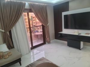 a living room with a large window and a television at Arizona luxury in Cairo