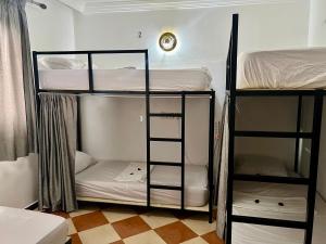 a room with three bunk beds in a room at Dar Oussama in Rabat