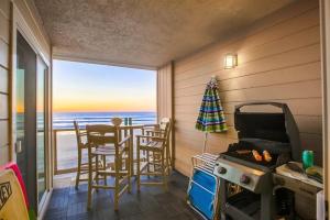 a room with a table and chairs and a view of the ocean at Salt Life in San Diego