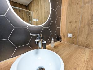 a bathroom with a white sink and a mirror at Appartement Place de la Cath' avec Parking in Colmar
